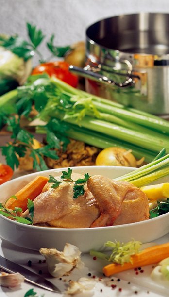 Geflügel in Auflaufform bei Zubereitung mit Gemüse ringsum ©AMA Marketing