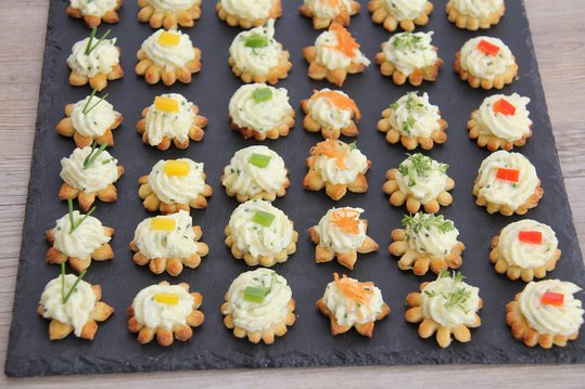 Nach dem Backen werden die Kekserl mit Erdäpfelkas verziert und nett angerichtet.