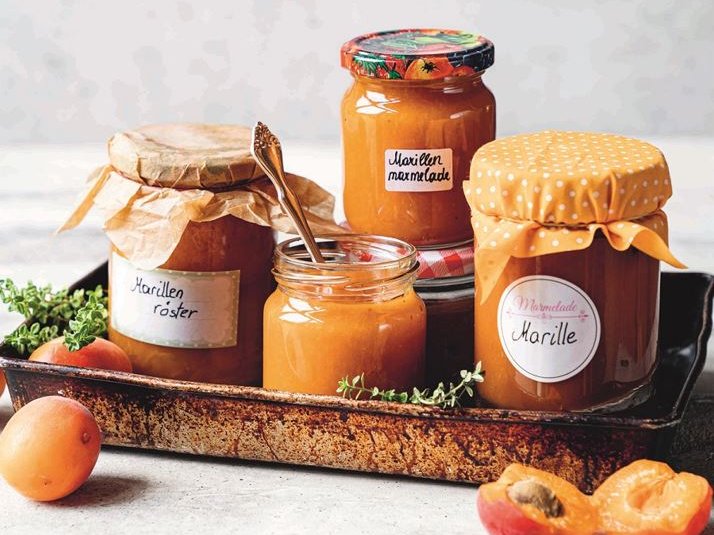 Marillenmarmelade und Marillenröster auf Tablett mit Marillen als Deko