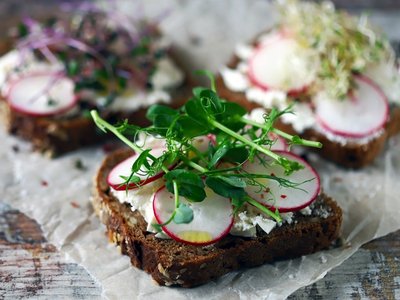 Selective focus. Healthy toasts with white cheese radish and mic