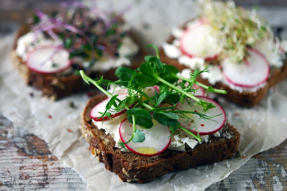 Selective focus. Healthy toasts with white cheese radish and mic