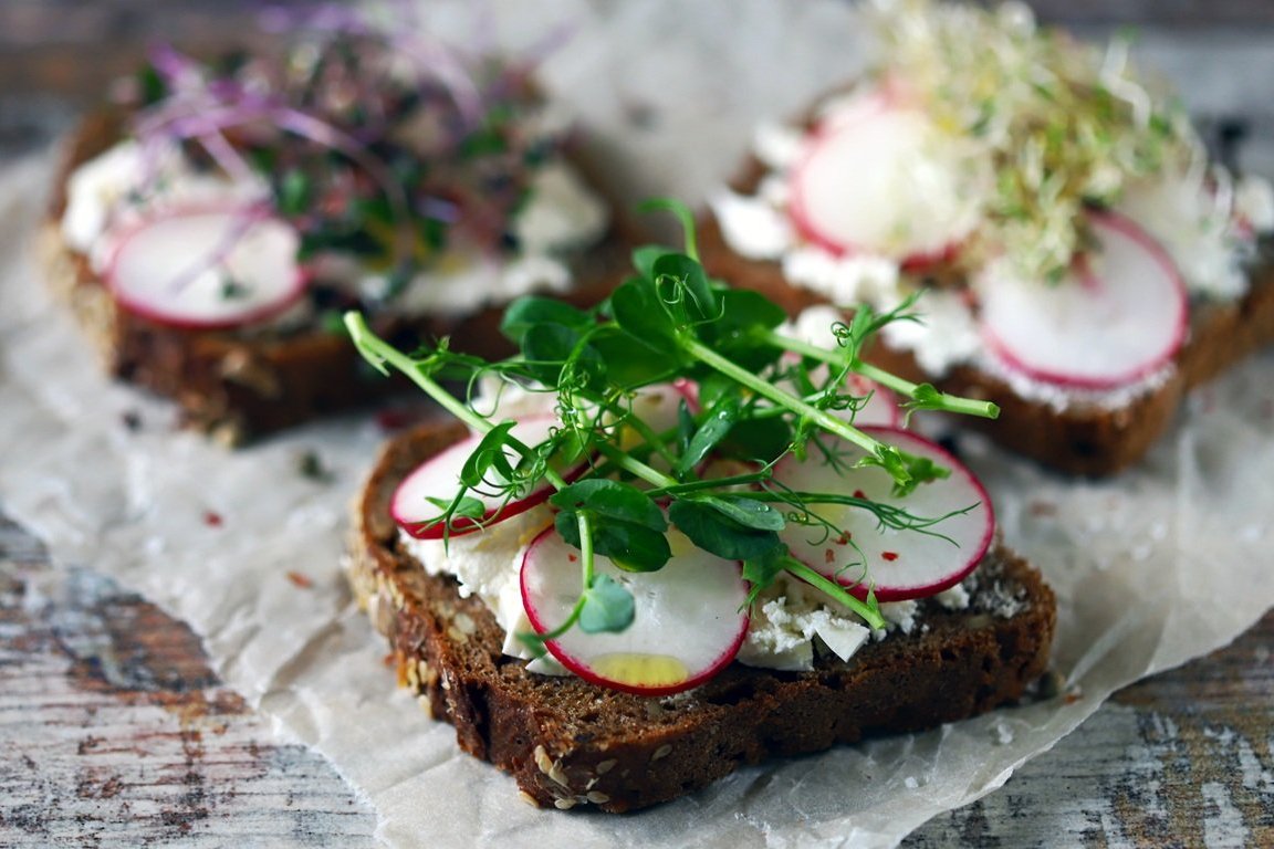 Selective focus. Healthy toasts with white cheese radish and mic