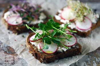Selective focus. Healthy toasts with white cheese radish and mic