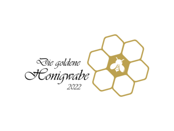 Goldene Waben mit Honigbiene und schwarzem Text "Die goldene Honigwabe 2022"