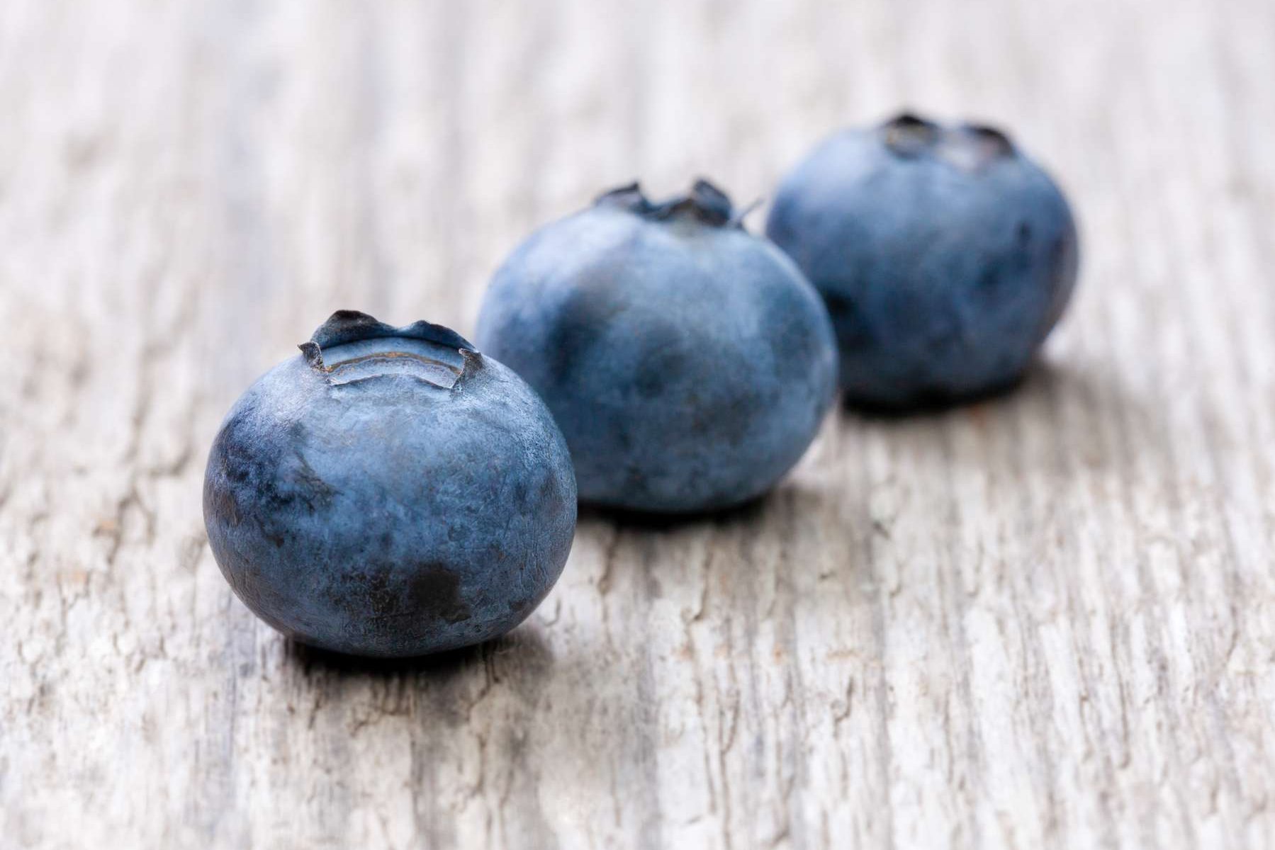 Heidelbeeren liegen auf einem Holztisch