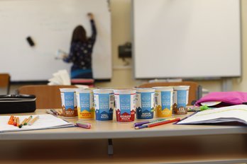 Die gefüllten Schulmilch-Gläsern in einer Kiste werden verschlossen und beschriftet.