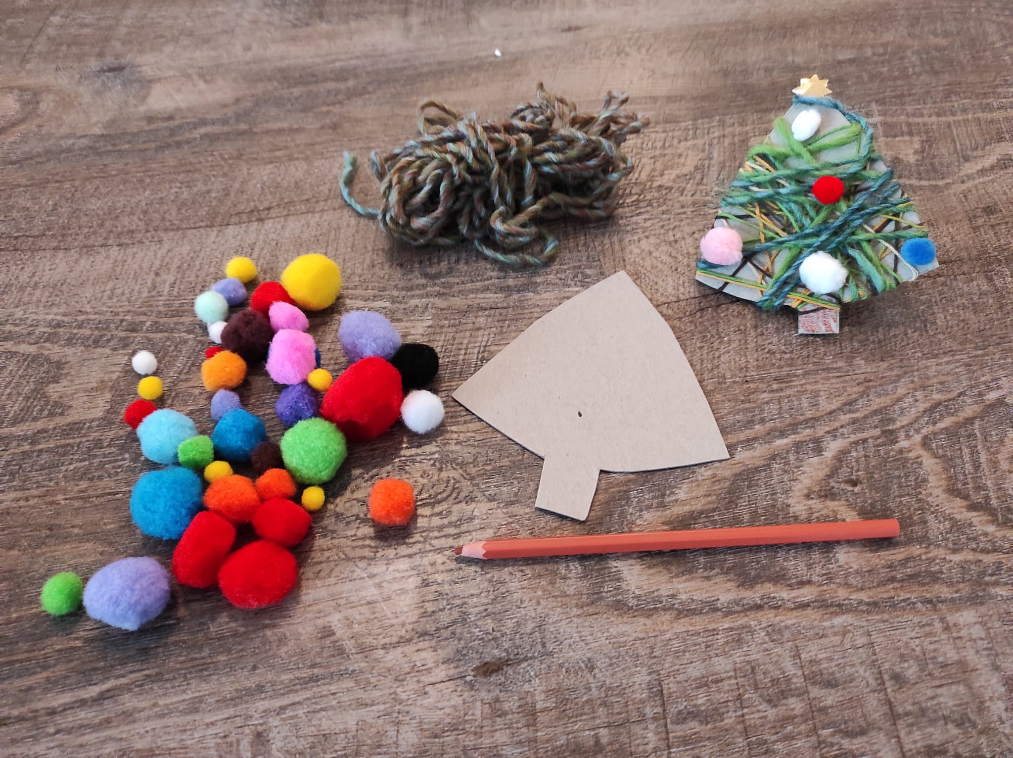 Bastelanleitung mit Karton, Stift, Wolle, Kleber, Filzkugeln, Papier für Christbäume